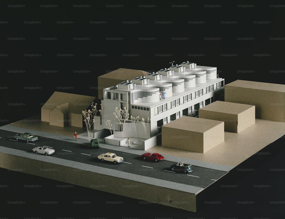 a model of a building with cars parked in front of it