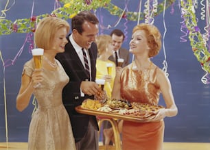 a man and two women are holding a tray of food