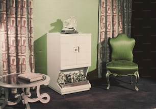 a green chair and a white cabinet in a room
