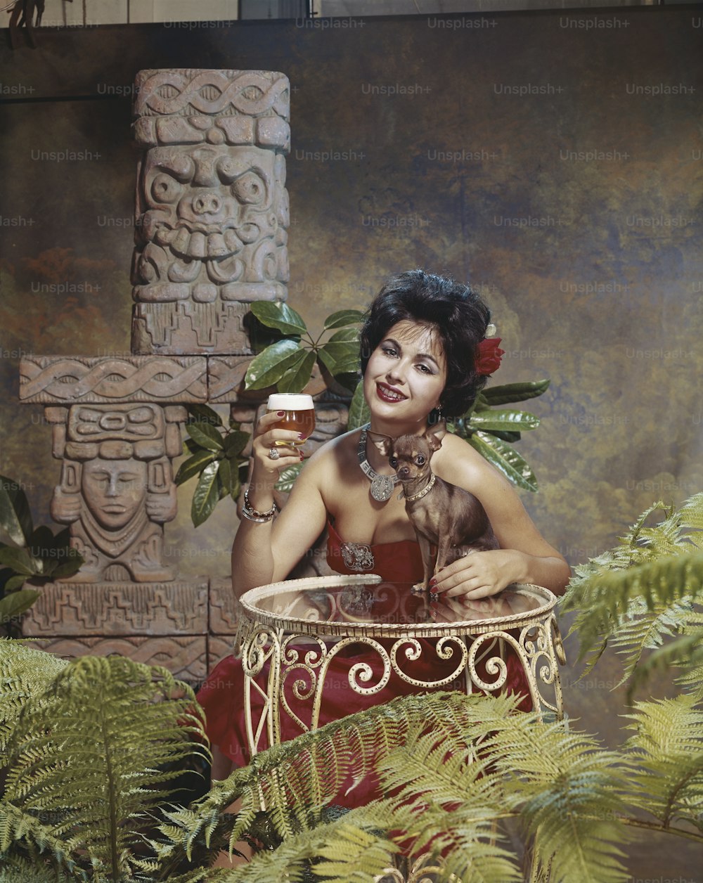 a woman in a red dress holding a glass of beer