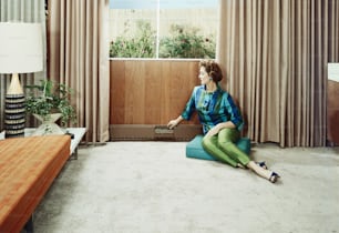 a woman sitting on the floor in a living room
