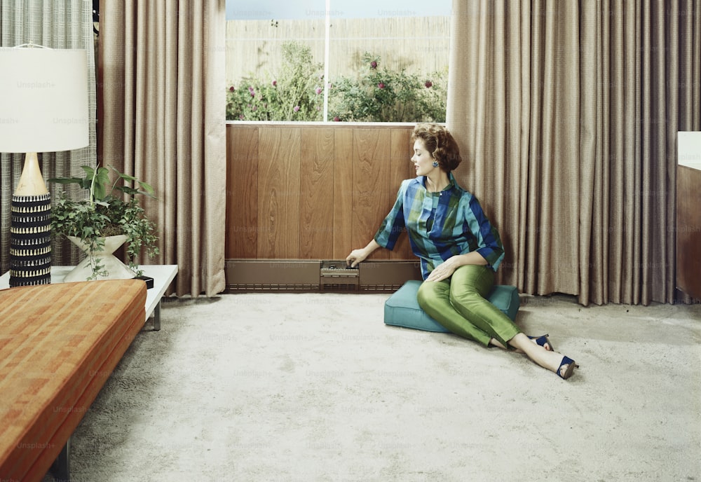a woman sitting on the floor in a living room
