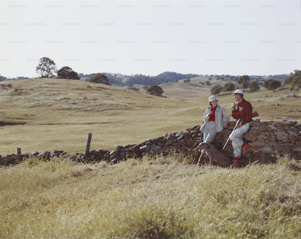 a couple of people that are standing in the grass