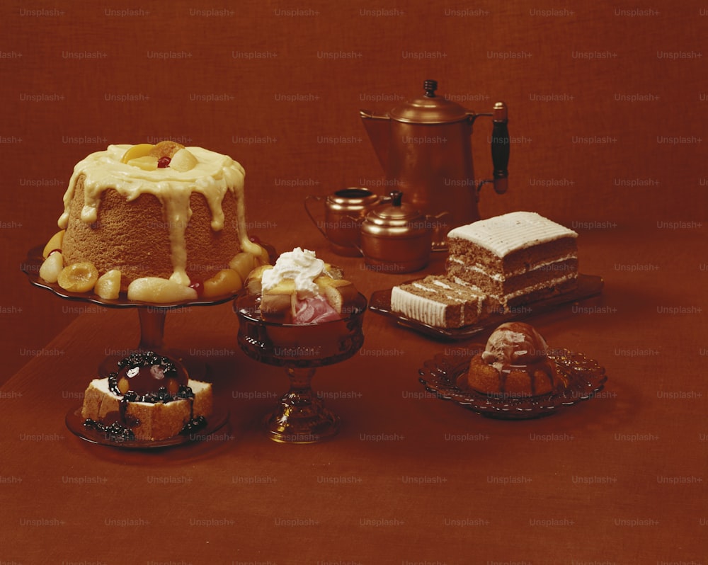a table topped with cakes and other desserts
