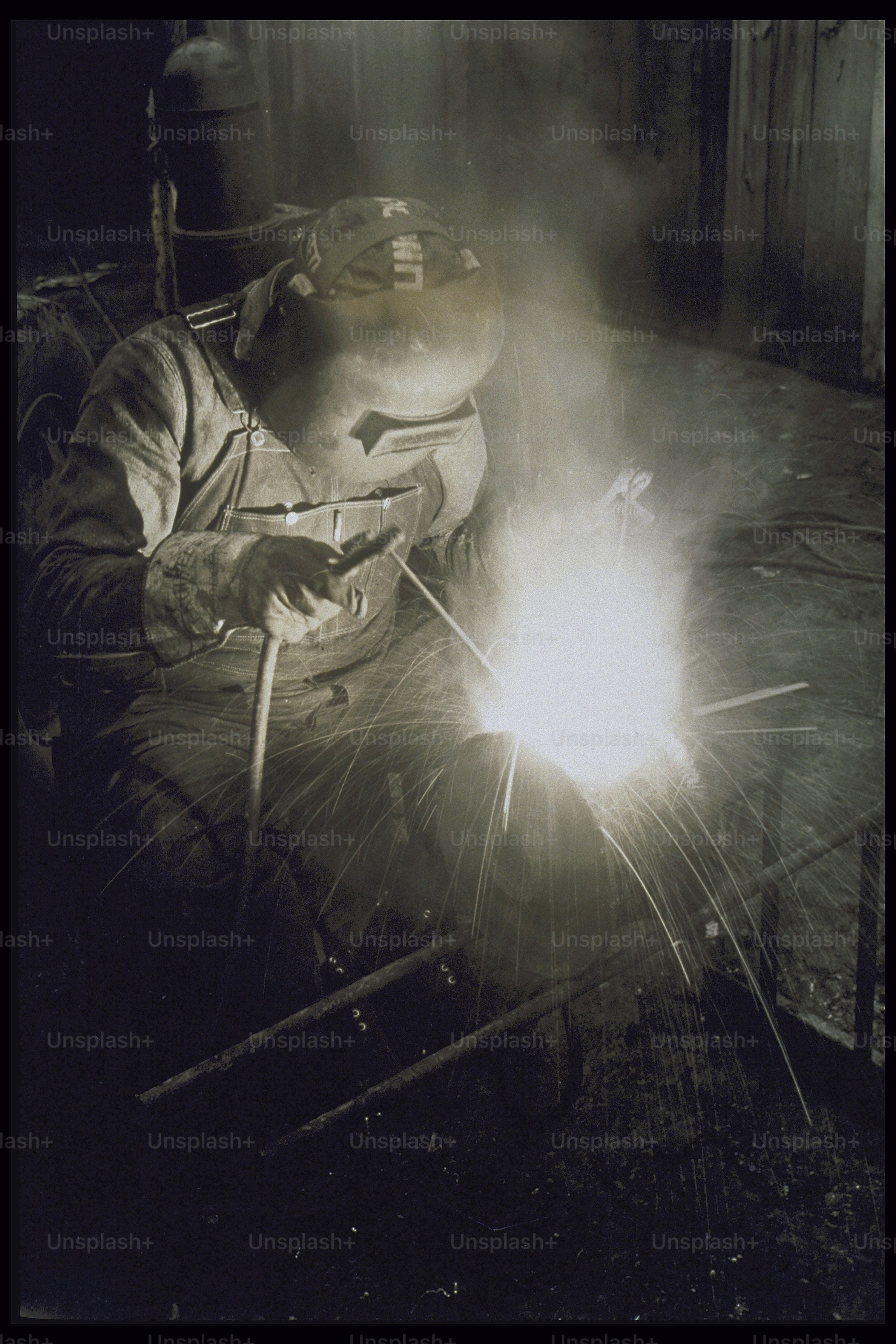 Welder working on light gauge steel metal piece