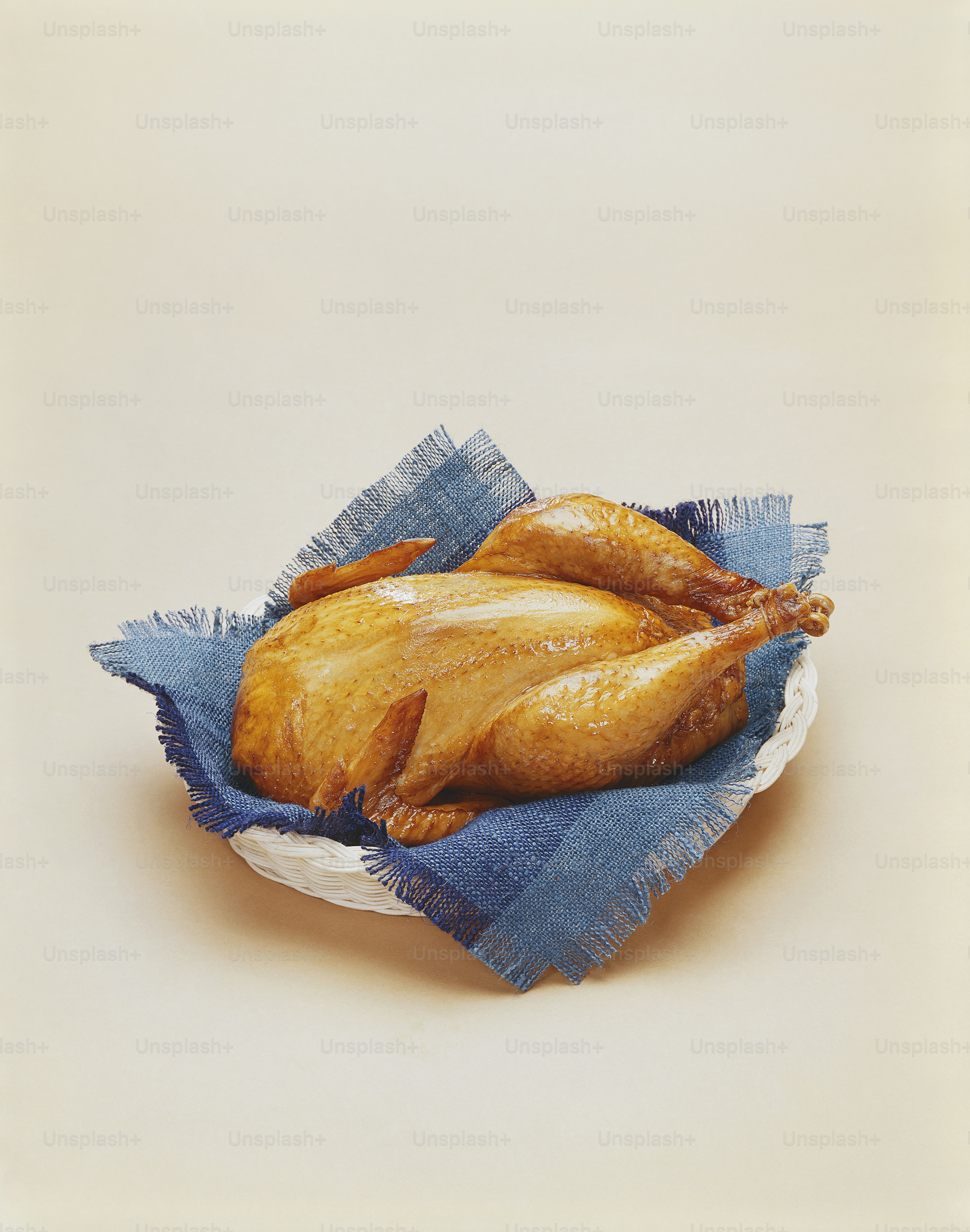 a painting of a chicken on a blue cloth