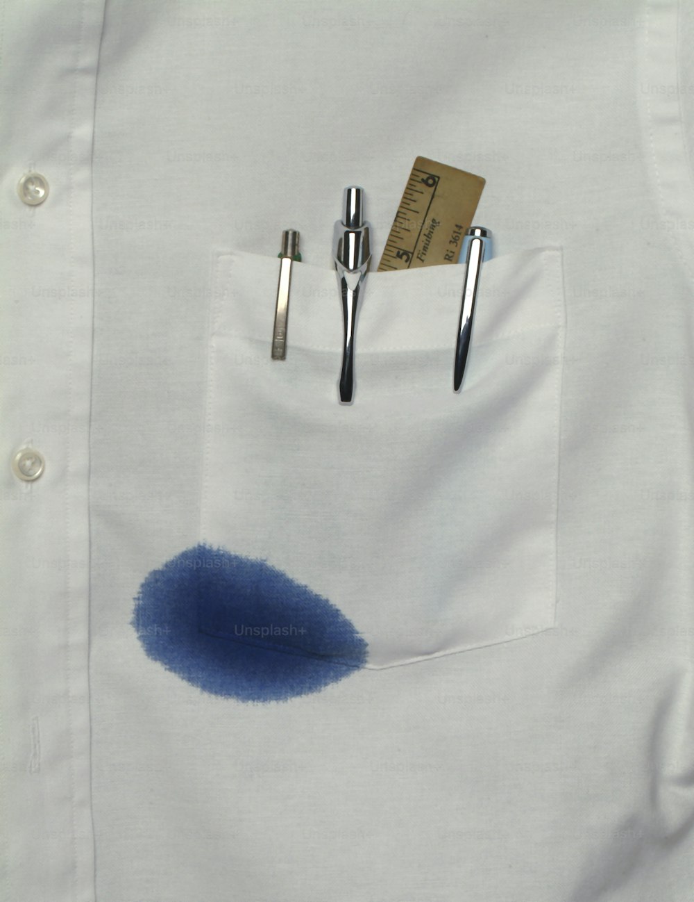 Close-up view of a shirt pocket that holds a ruler and several pens, one of which leaks blue ink, California, 1970s. (Photo by Tom Kelley/Getty Images)