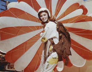 a woman in a costume holding a large umbrella