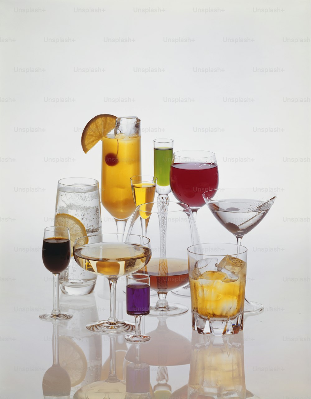 a bunch of glasses of different kinds of drinks