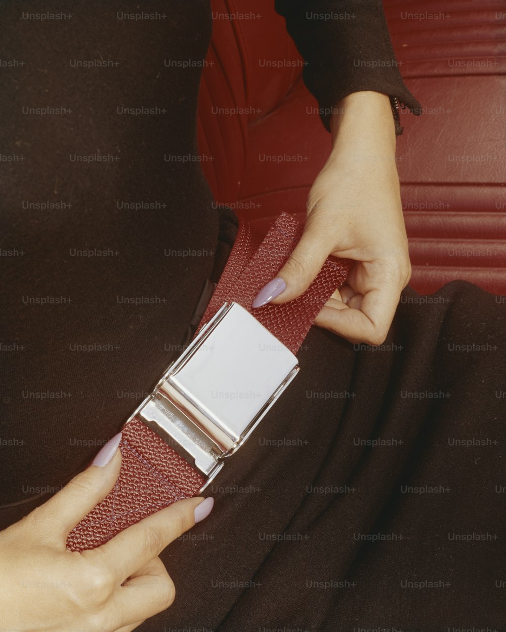 a woman is holding a belt around her waist
