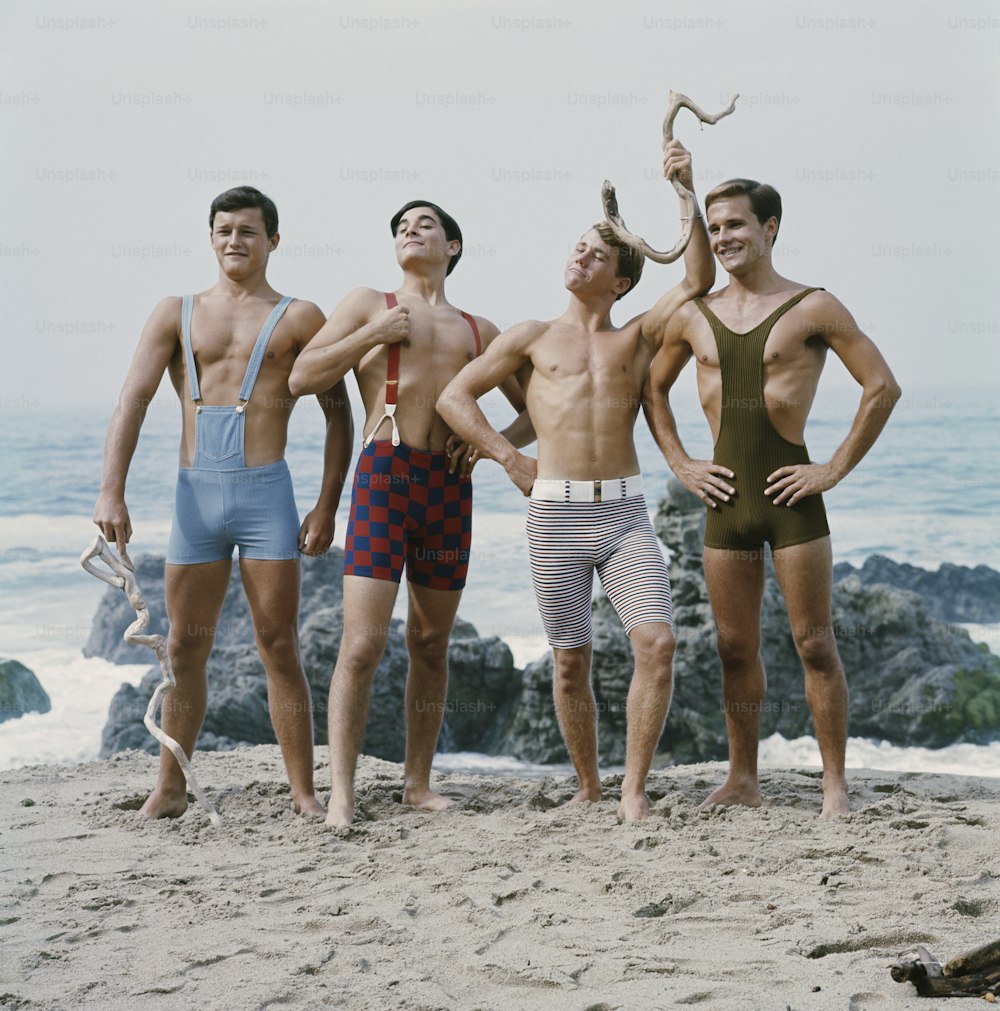 a group of men standing next to each other on a beach