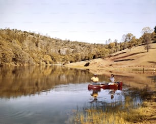 two people in a canoe on a lake