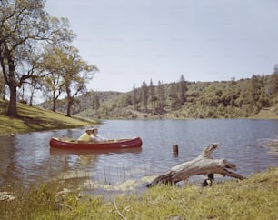 two people in a canoe on a lake