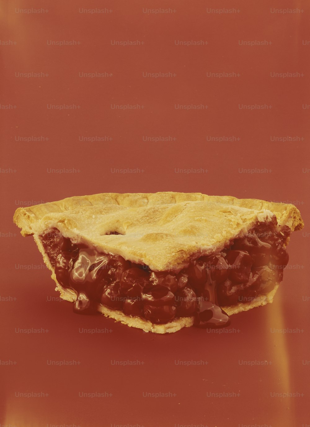 a piece of food sitting on top of a red surface