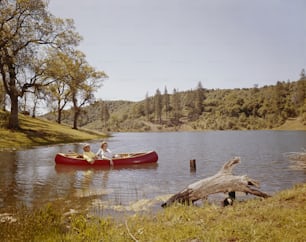 two people in a canoe on a lake