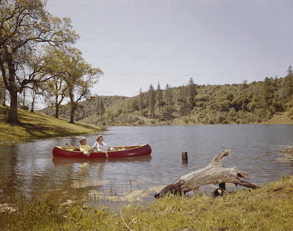 two people in a canoe on a lake