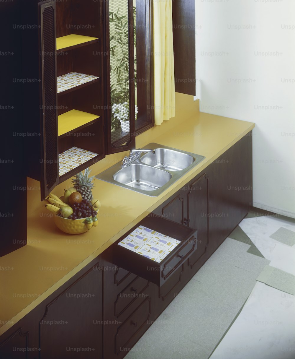 a kitchen counter with a sink and a shelf