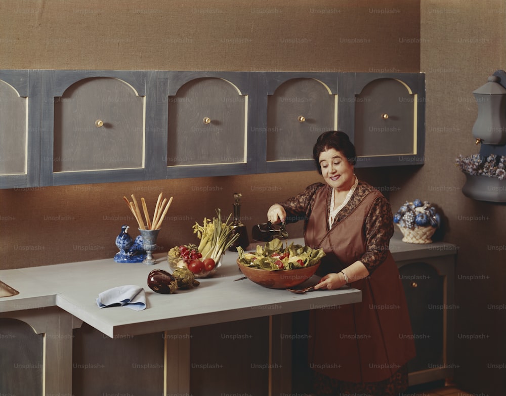 a woman in a kitchen preparing food on a counter
