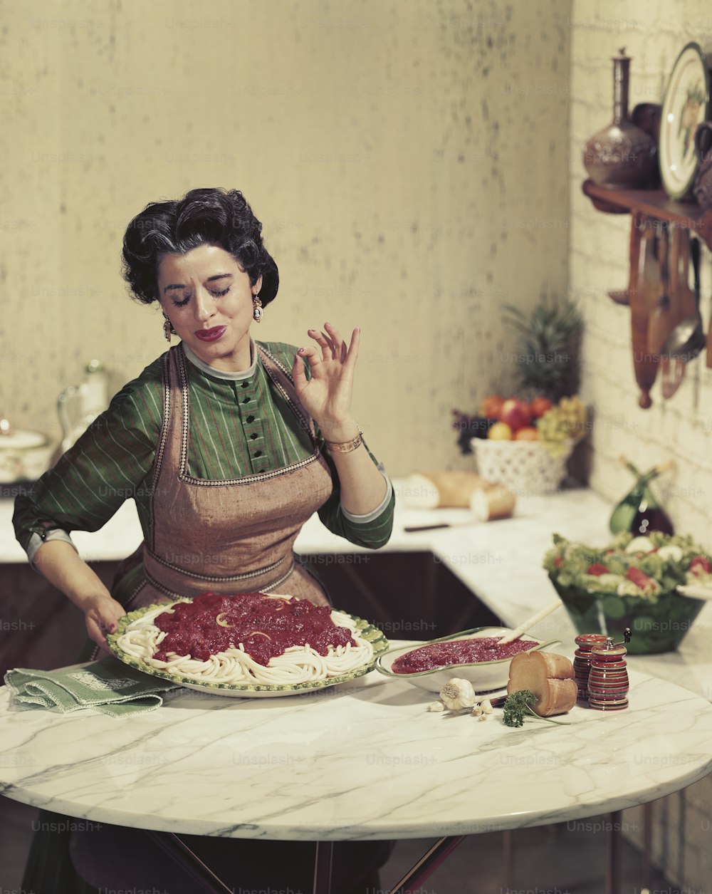 a woman in an apron is making a cake