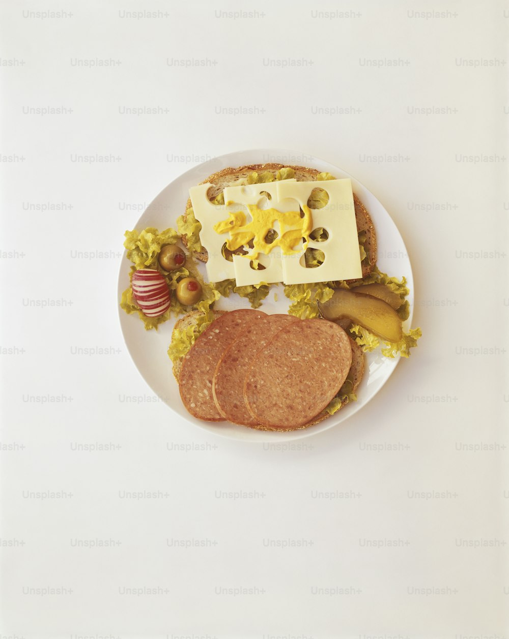 a white plate topped with a sandwich and fruit