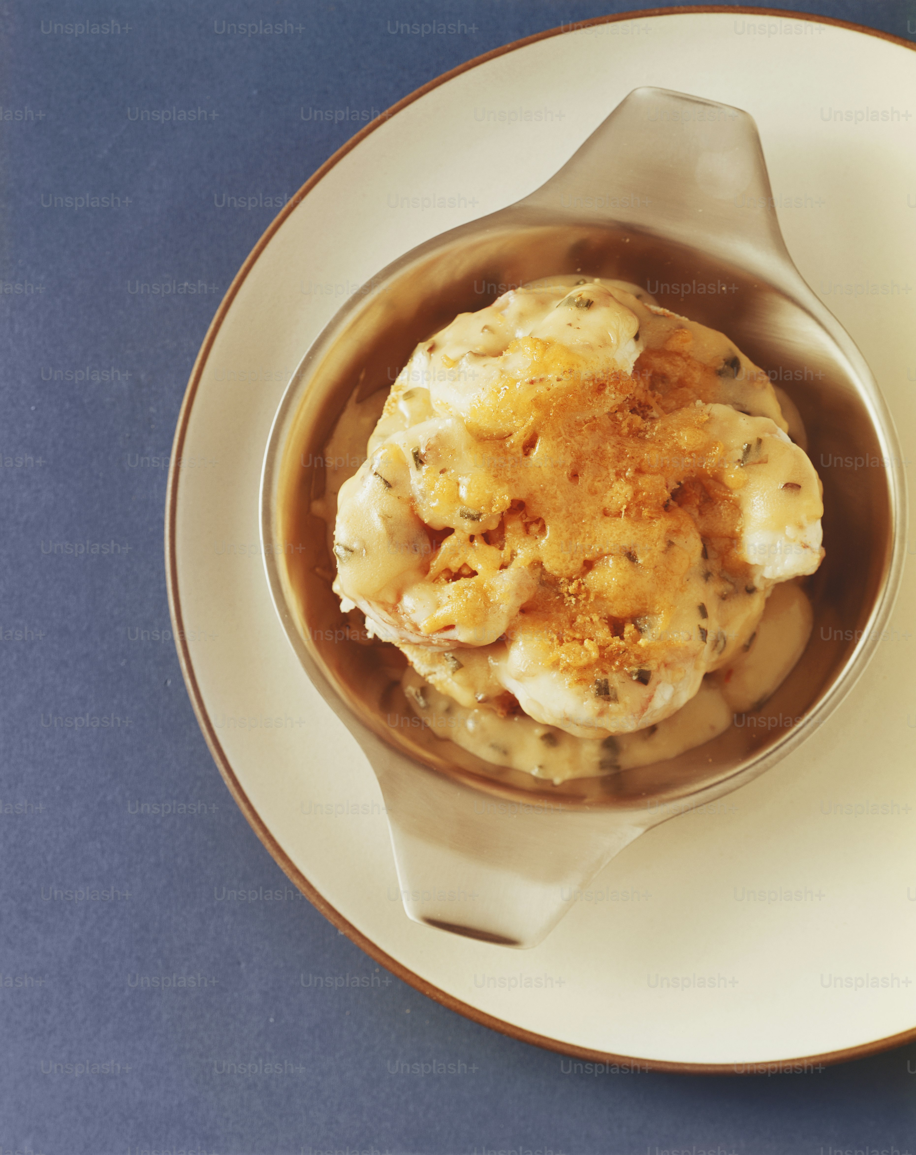 a bowl of food on a plate with a spoon