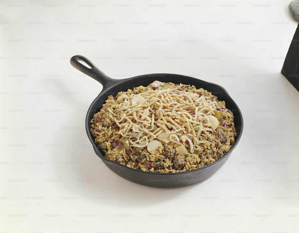 a pan filled with food sitting on top of a table