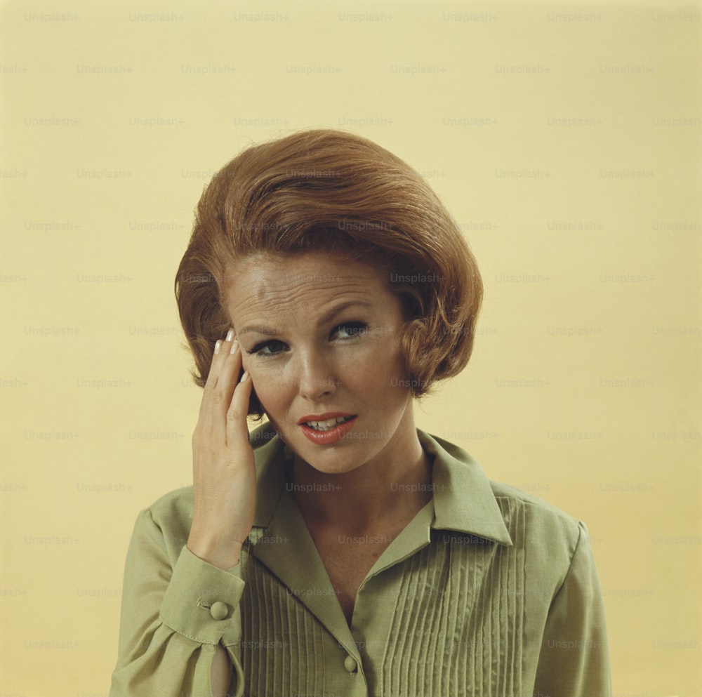 a woman in a green shirt talking on a cell phone
