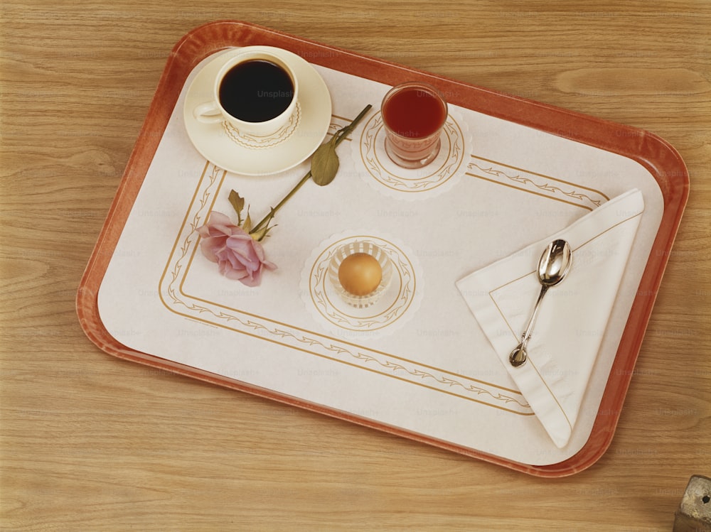 a tray with two cups of coffee and a napkin