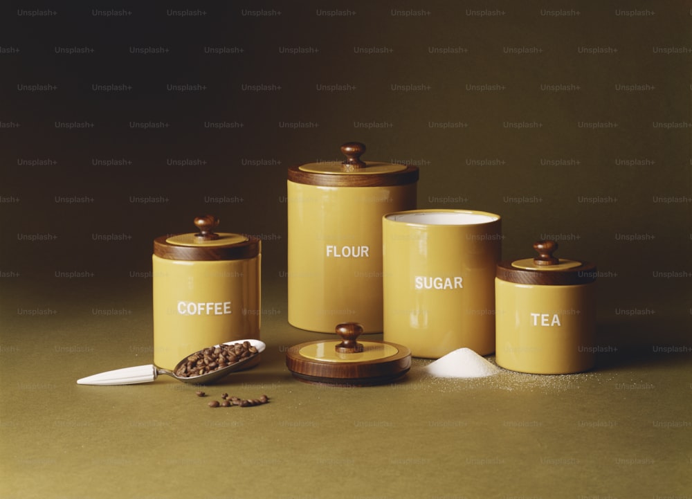 a group of yellow canisters sitting on top of a table
