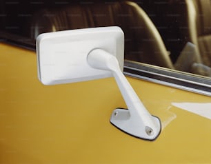 a white door handle on a yellow car