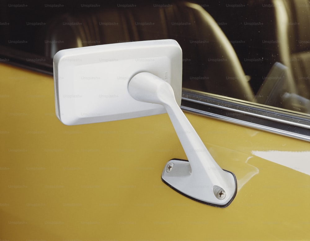 a white door handle on a yellow car