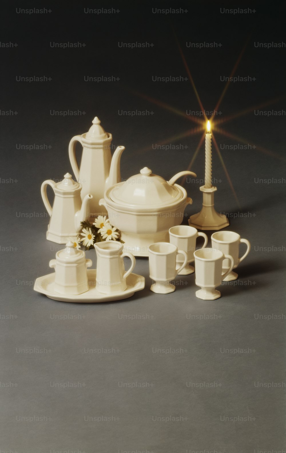 a tea set with a tea pot and cups