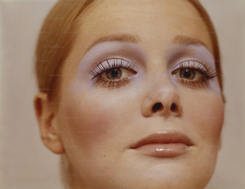 a close up of a woman with long eyelashes