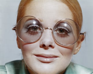 a close up of a person wearing glasses