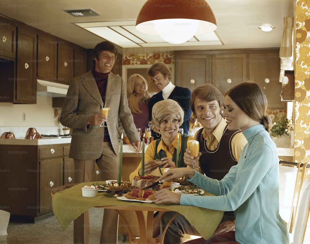 a group of people sitting around a table eating food