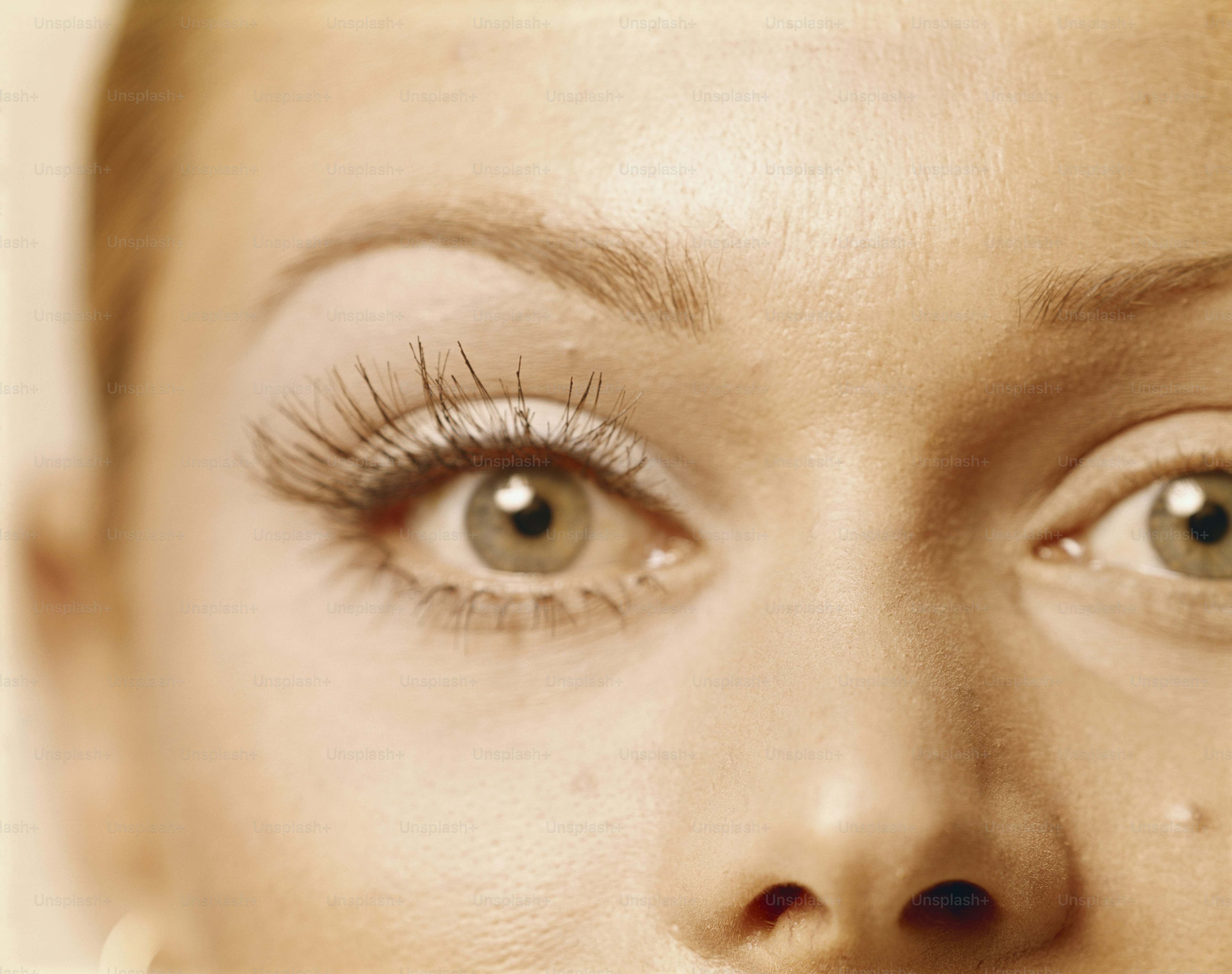 a close up of a woman's face with long lashes