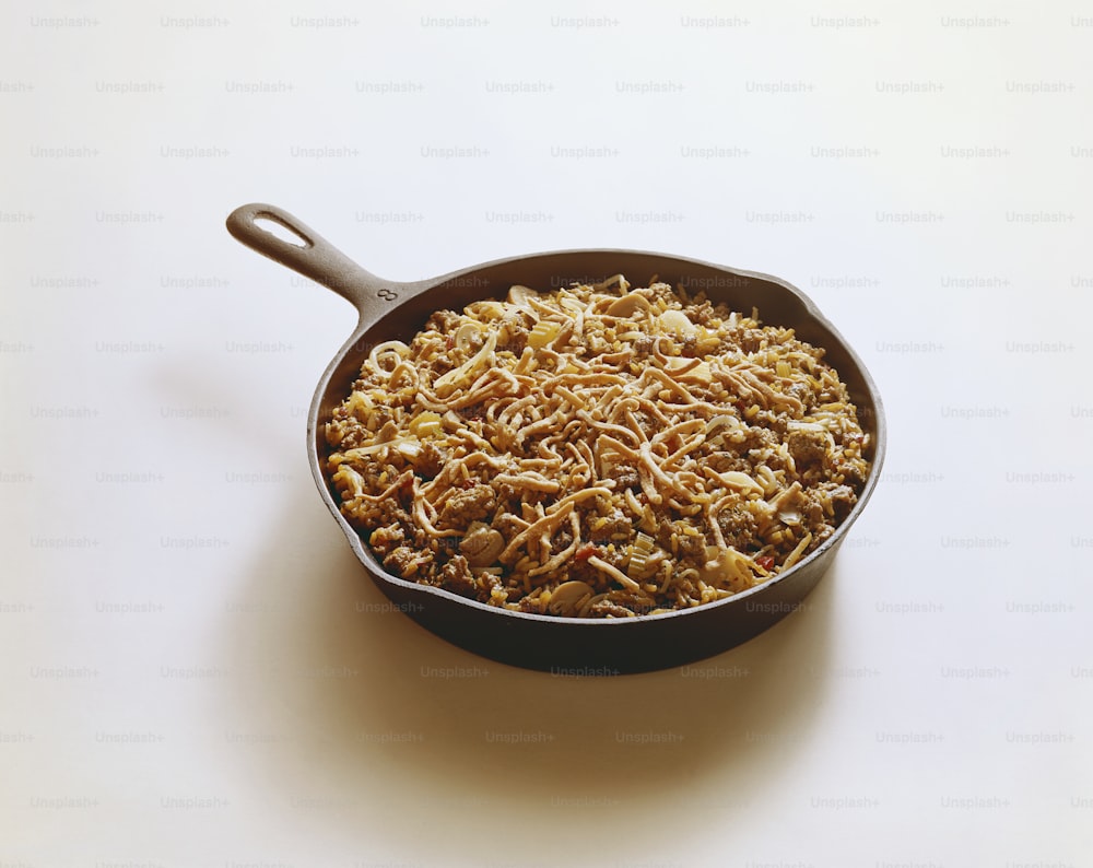 a pan filled with food sitting on top of a table