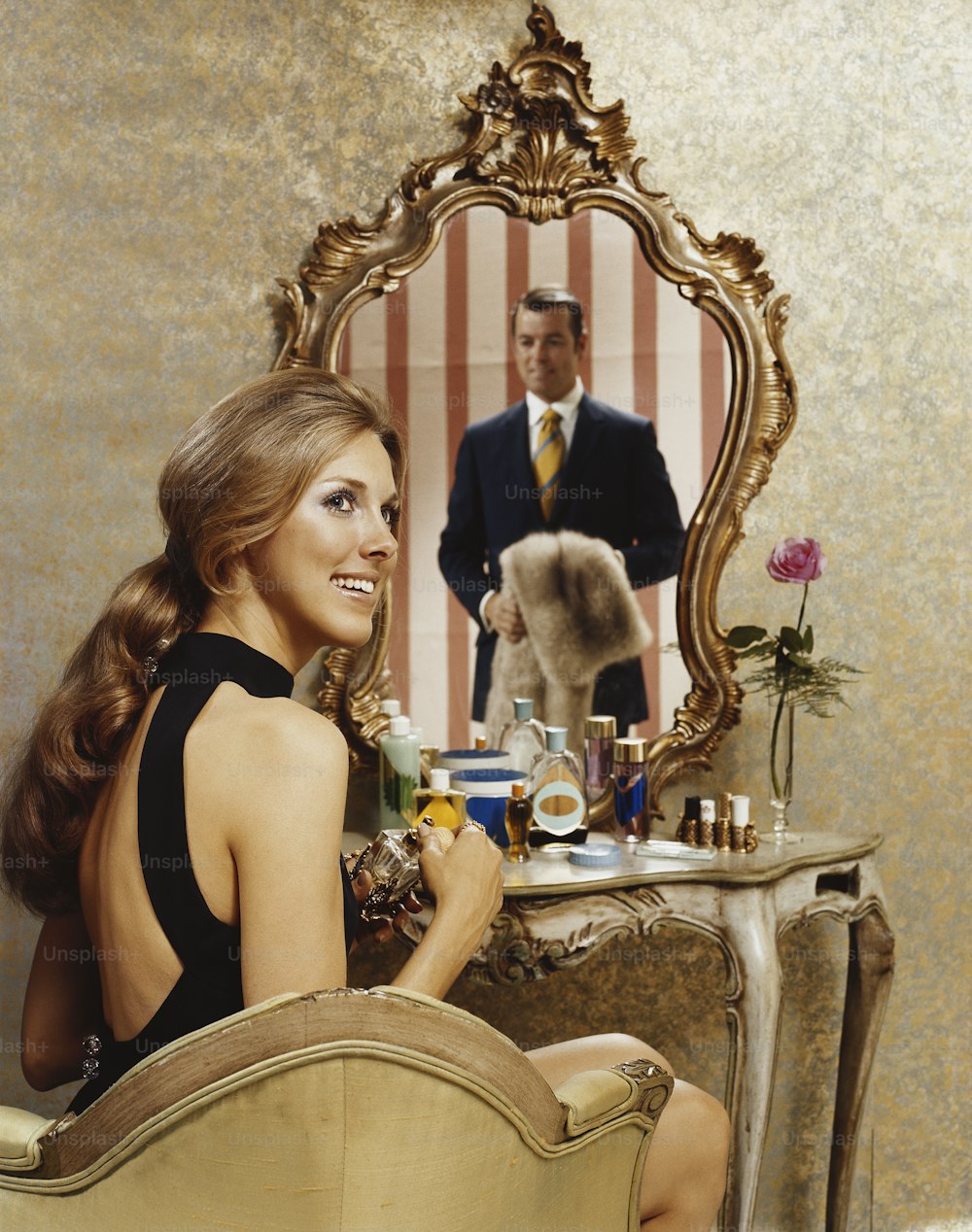a woman sitting in a chair in front of a mirror