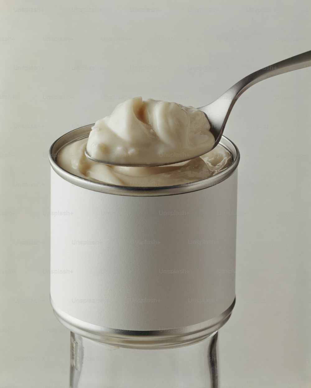 a spoon full of whipped cream in a jar