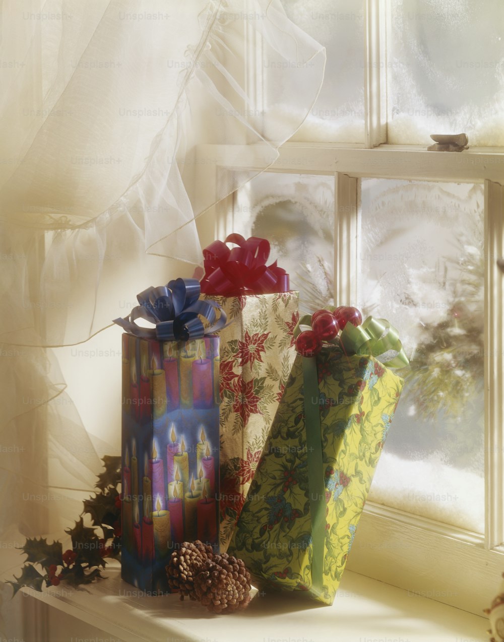 a group of wrapped presents sitting on top of a window sill