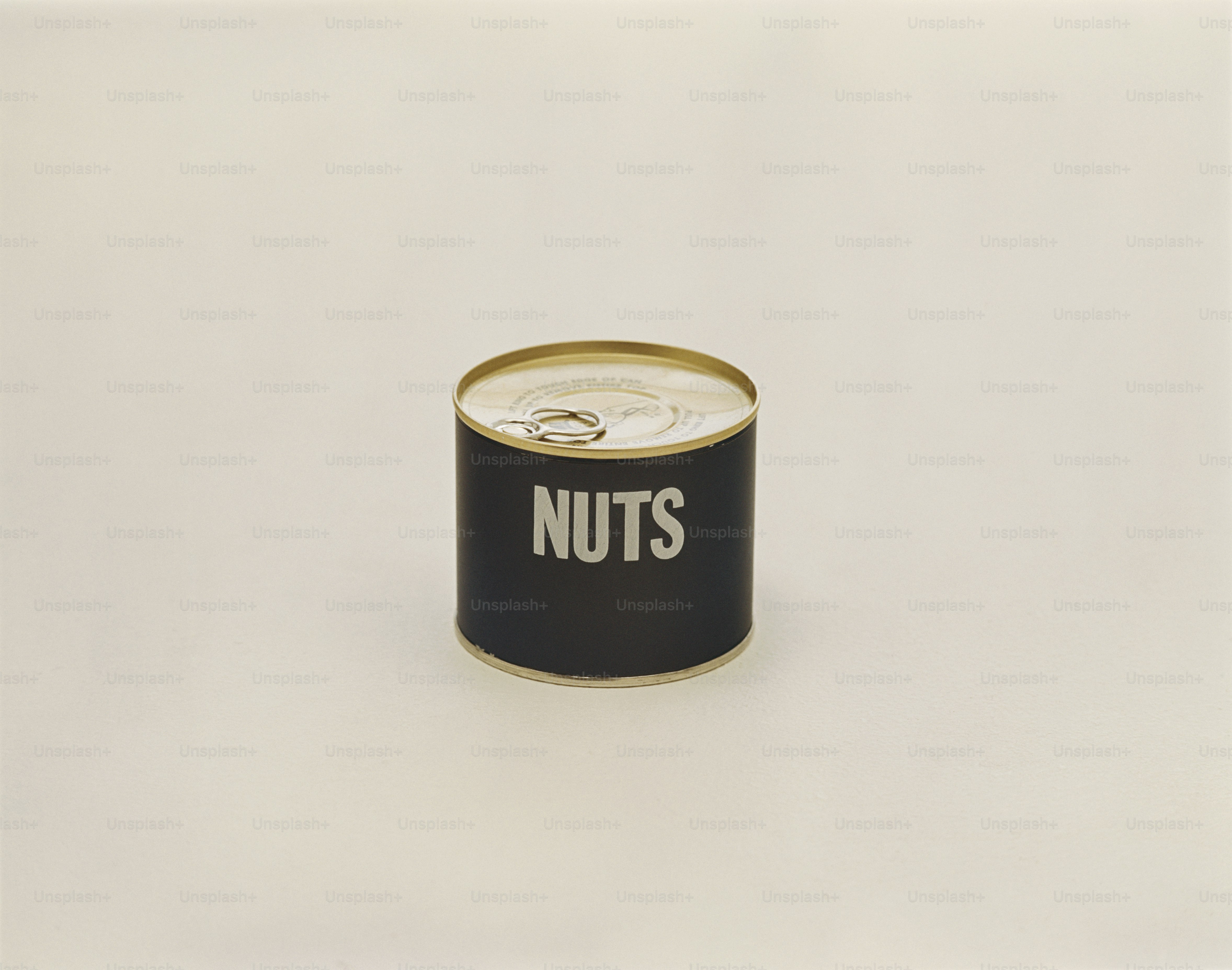 a can of nuts on a white surface