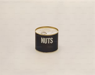 a can of nuts on a white surface