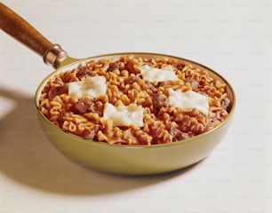 a bowl of pasta with meat and cheese