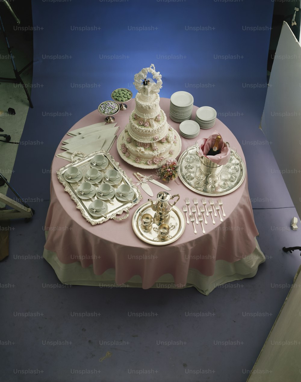 a table topped with a cake and cupcakes