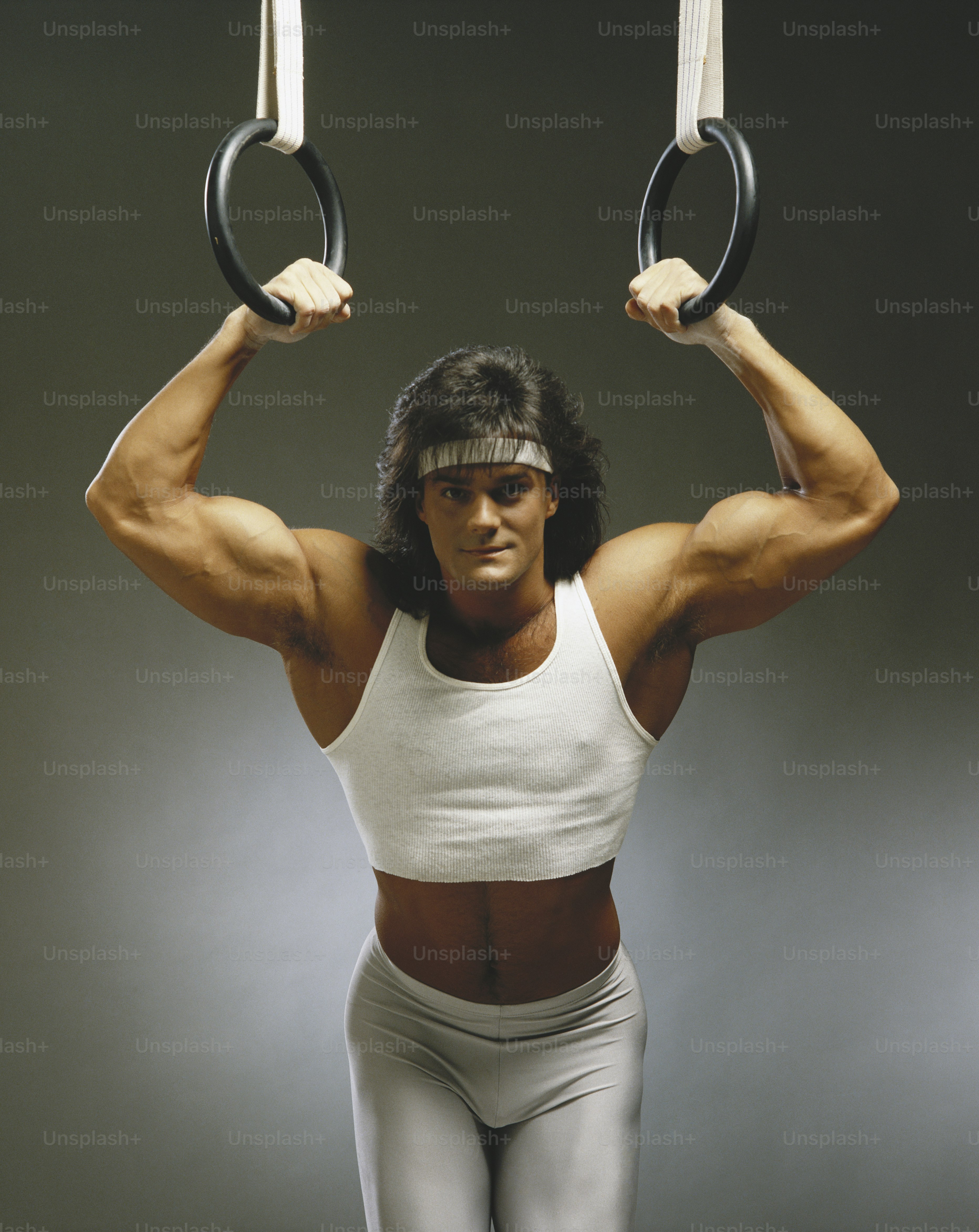 a man holding two rings above his head