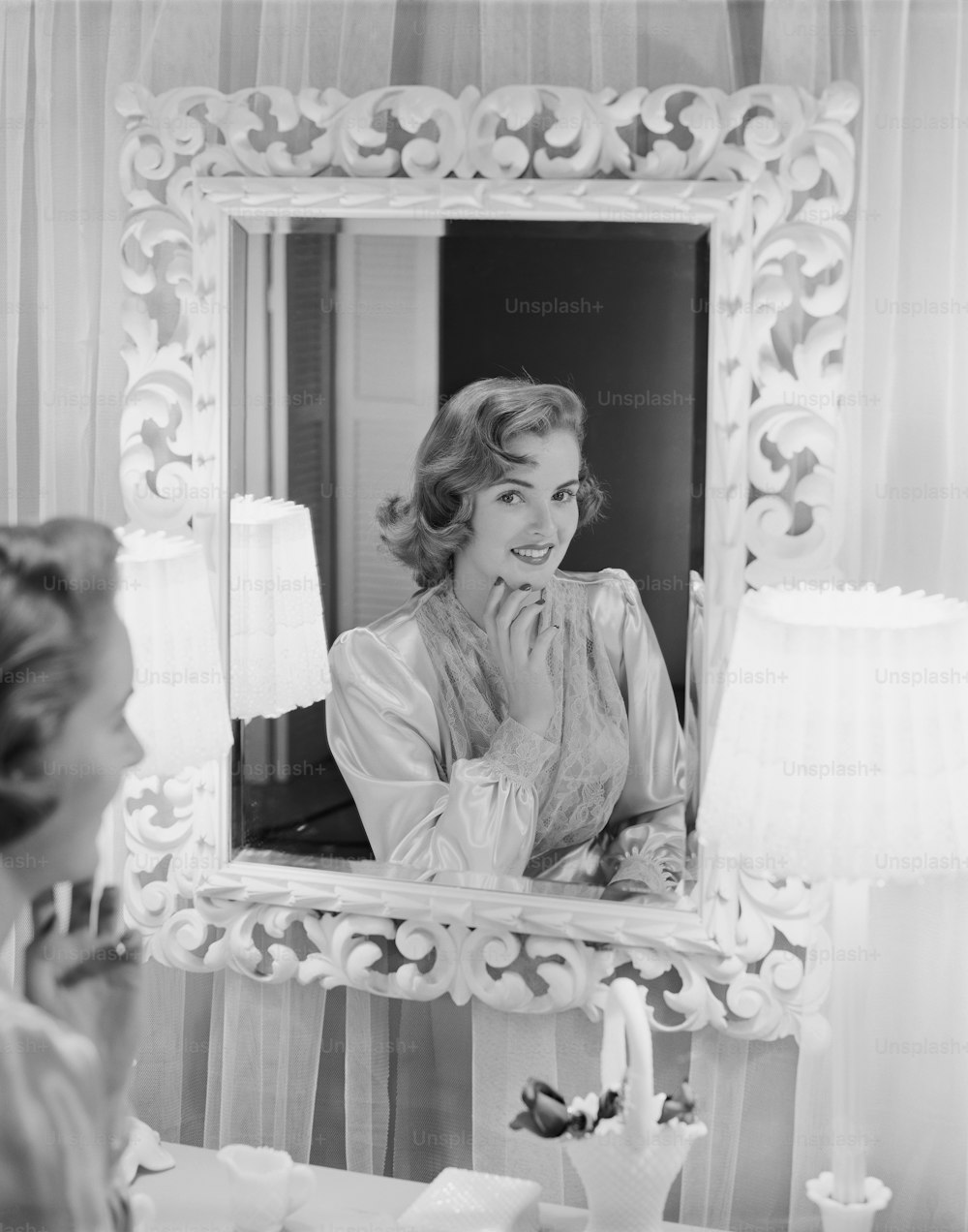 a woman looking at her reflection in a mirror