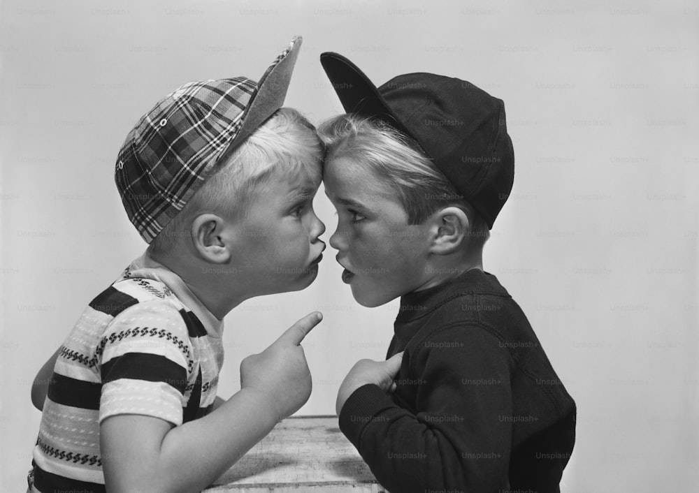 two young boys are kissing each other
