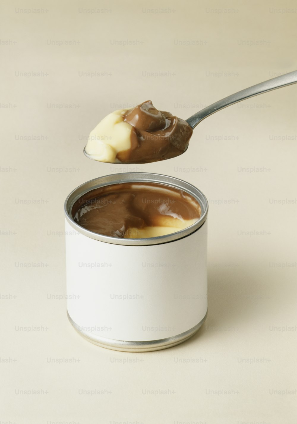 a spoon full of chocolate pudding with a bite taken out of it
