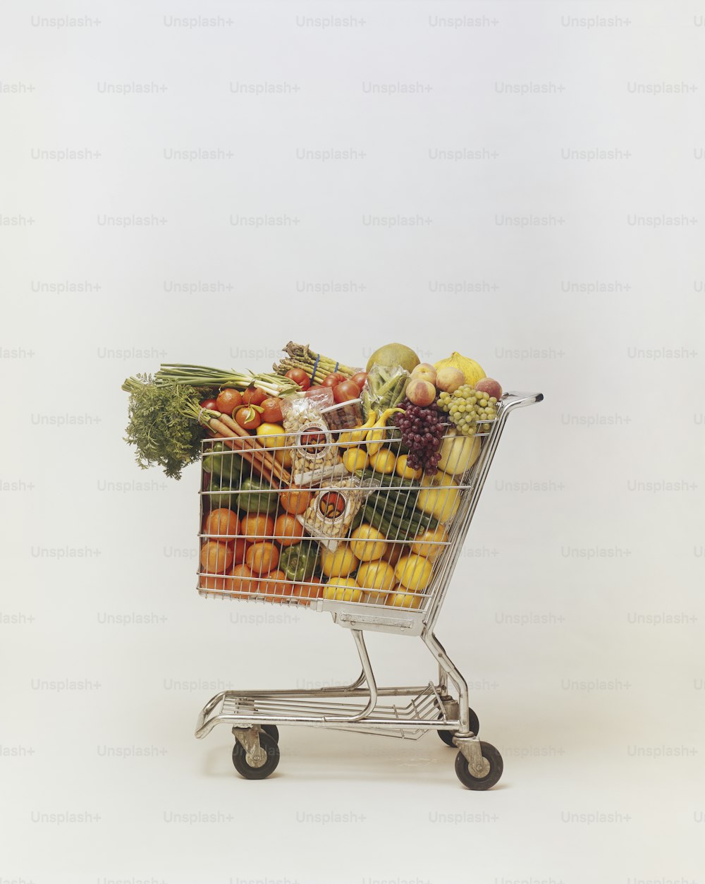 a shopping cart full of assorted fruits and vegetables