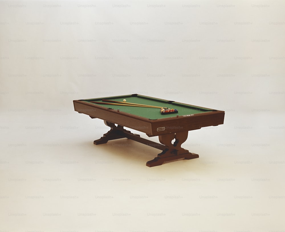 a pool table with a green cloth on it